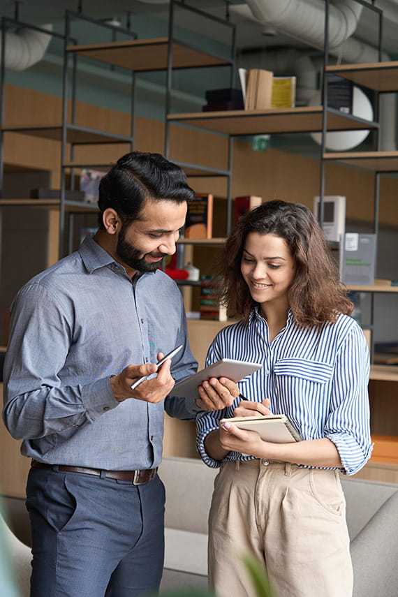Two people looking at a tablet